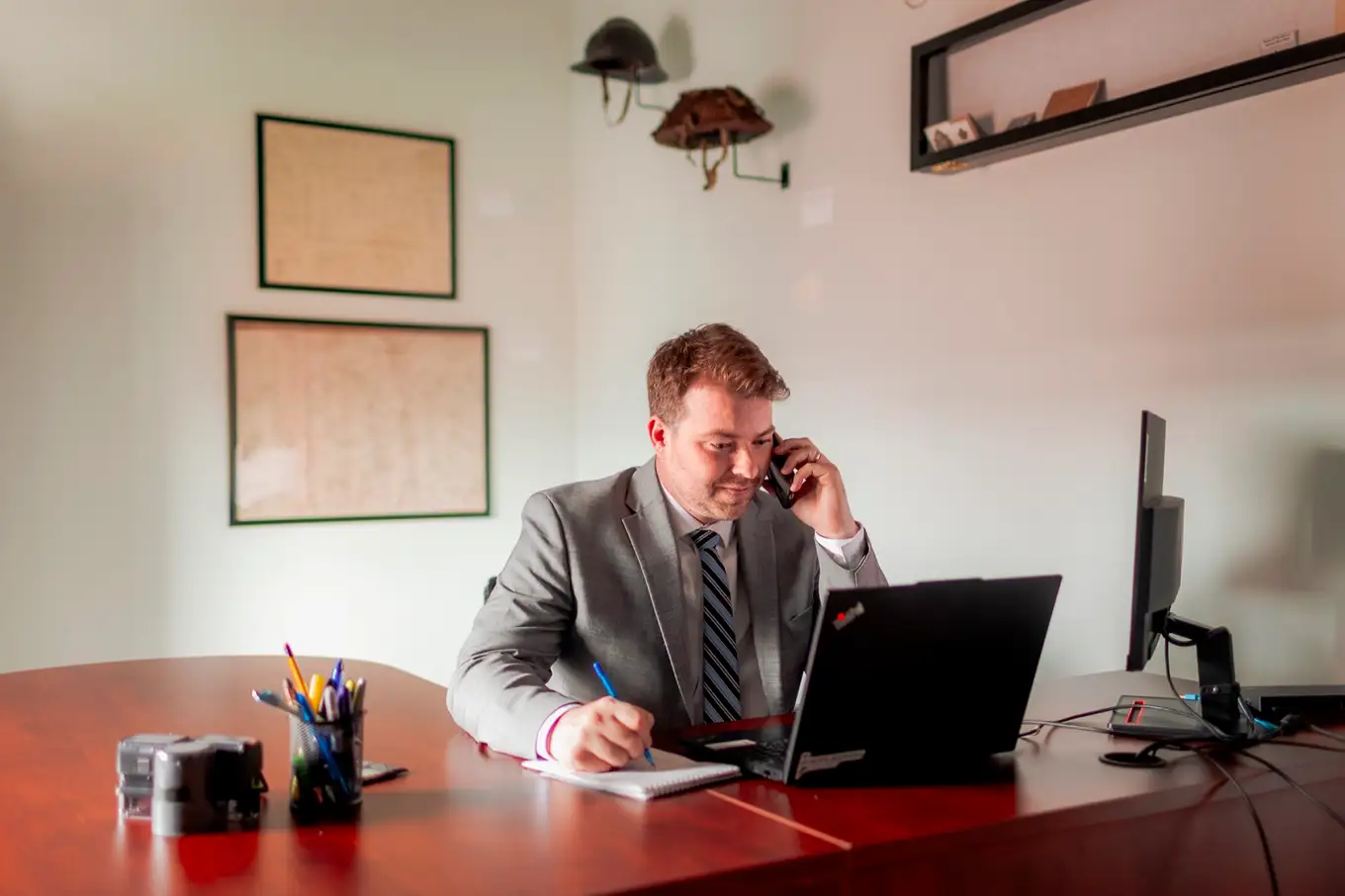 Curran Tompkins on a call at his desk in the Moncton office