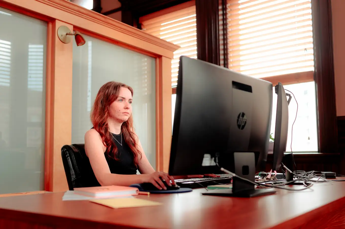 Emily O'Hara at the reception desk in the Moncton office