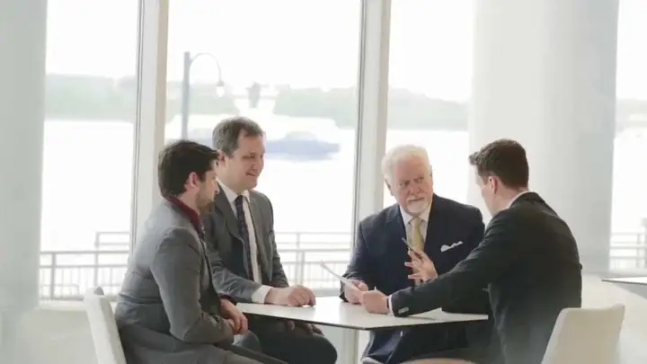 Mike Murphy Law Group lawyers meeting at a table by Halifax harbour