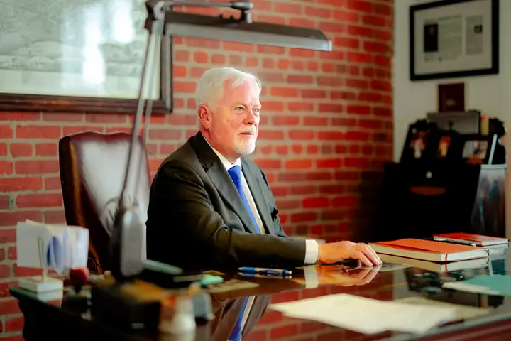 Michael Murphy, K.C. reading at his desk in the Moncton office