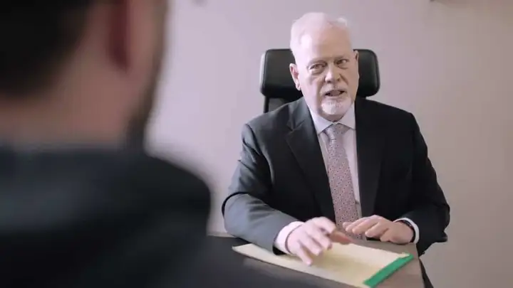 Michael Murphy speaking with a client across his desk