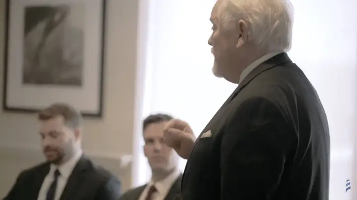 Michael Murphy briefing two lawyers in a meeting room