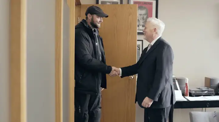 Michael Murphy greeting a client at the office door