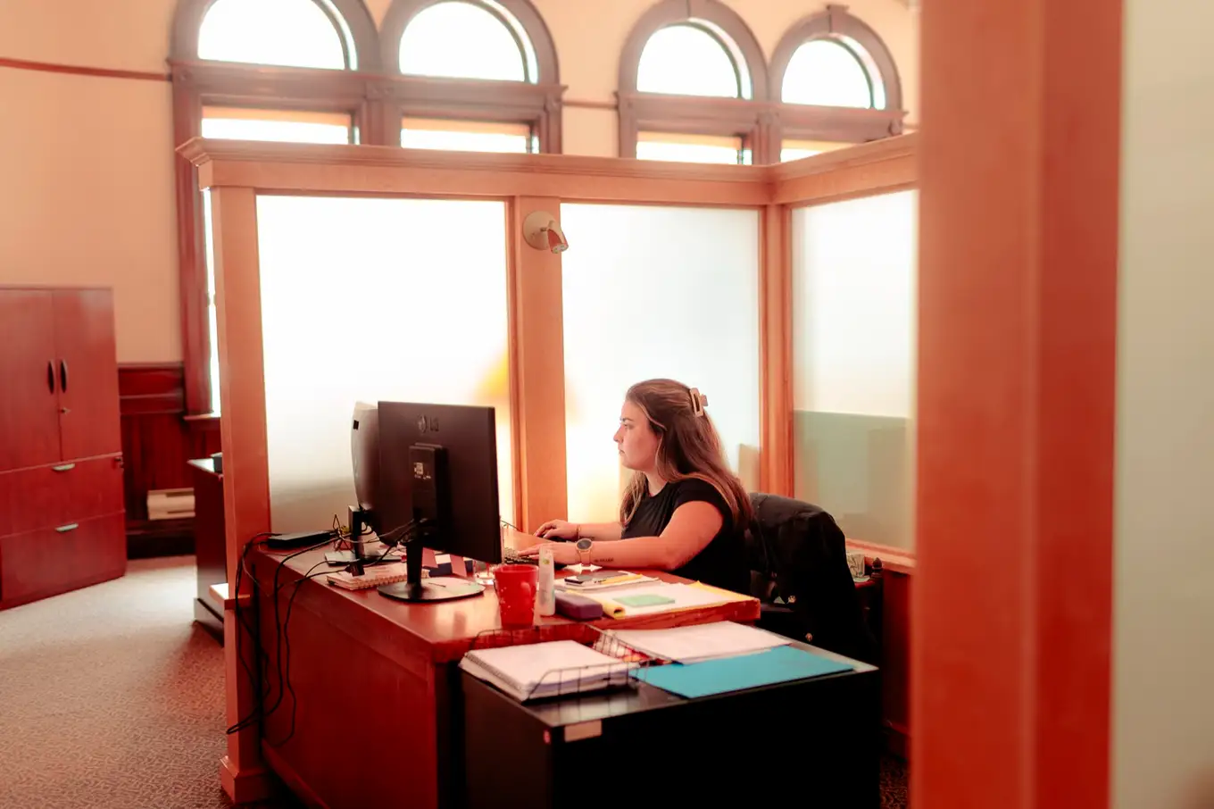 A member of the firm's Moncton team working at her desk