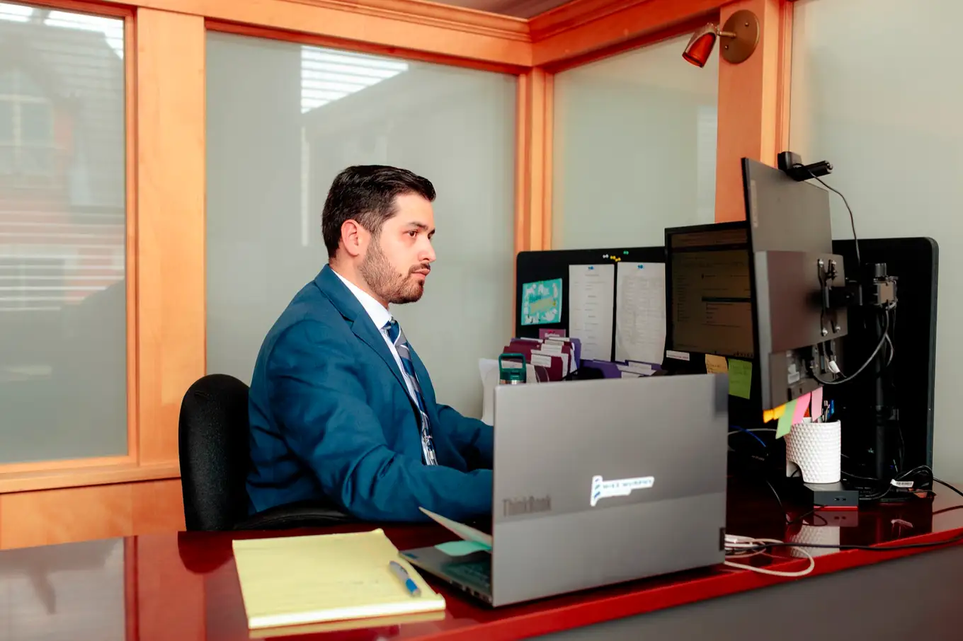 Terryn Camilleri at his desk in the firm's Moncton office