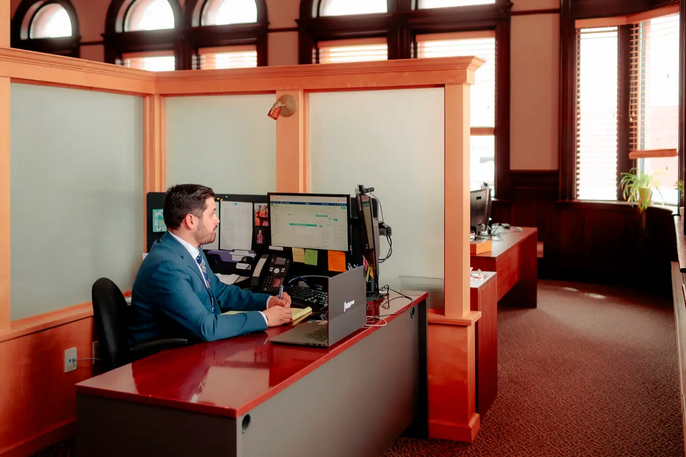 Terryn Camilleri with a legal pad at his desk in Moncton