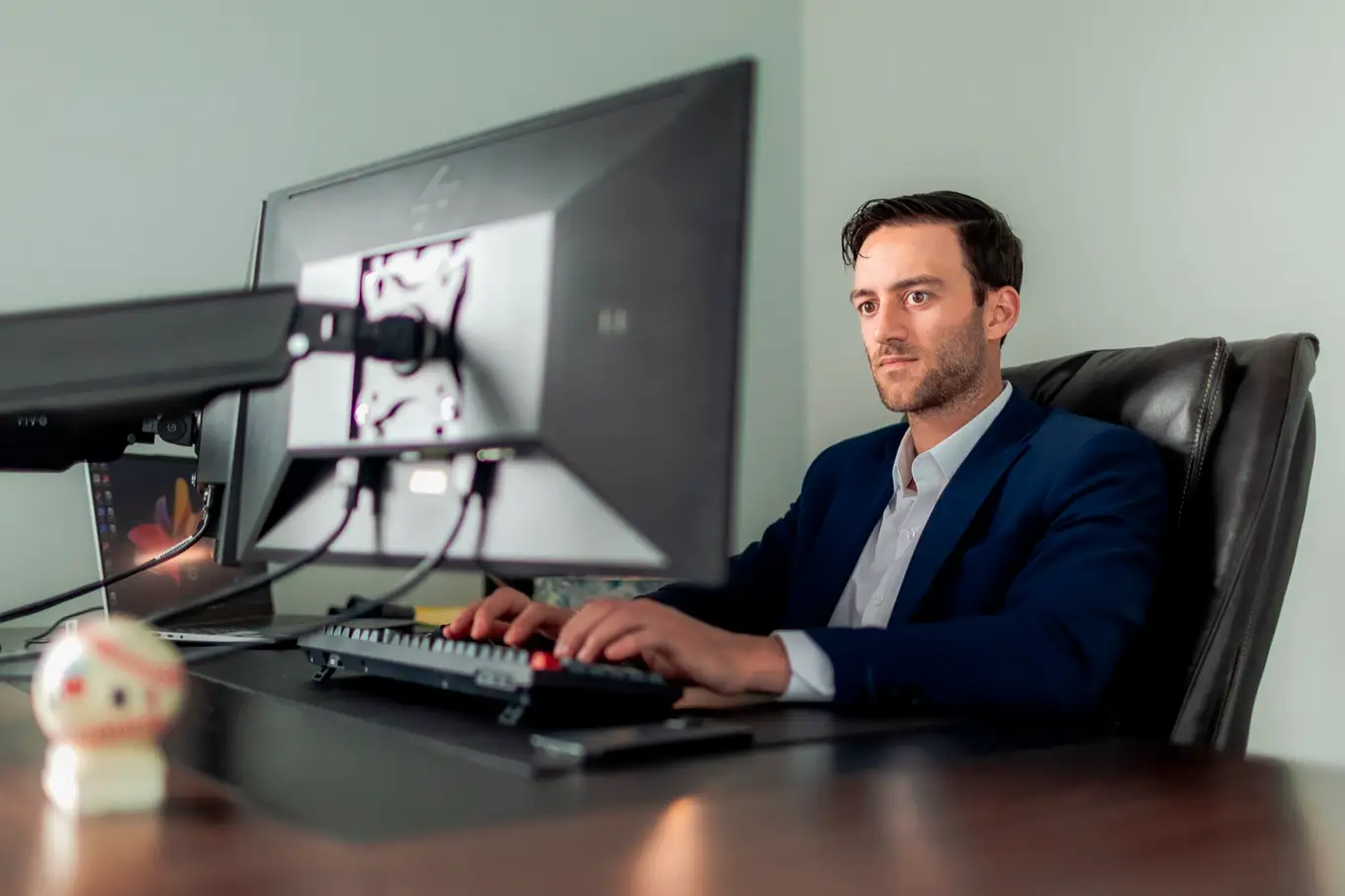 Vincent Savoie reading a file on screen in the Moncton office